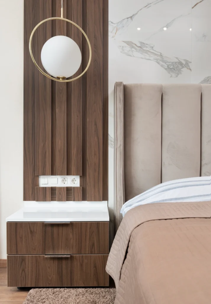 A bed room with a wooden headboard and a mirror